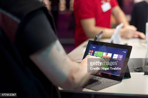 Visitor touches a surface tablet at the Microsoft stand at the 2014 CeBIT technology Trade fair on March 10, 2014 in Hanover, Germany. CeBIT is the...