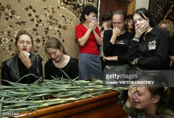 Classmates of Derassa Bazrova cry near her coffin 05 September 2004 in Beslan, North Ossetia. The first funerals for the hundreds killed in the...