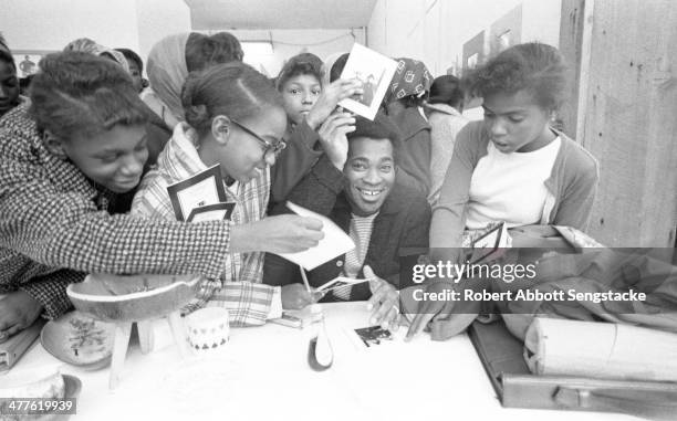 At Shepherd's Studio , photographer Billy 'Fundi' Abernathy signs cards for students and children during his 'Live Flicks of the Hip World'...