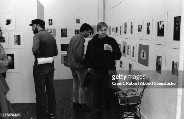 View of unidentified people at an exhibition of photographer Billy 'Fundi' Abernathy's works at Shepherd's Studio , Chicago, Illinois, 1967.