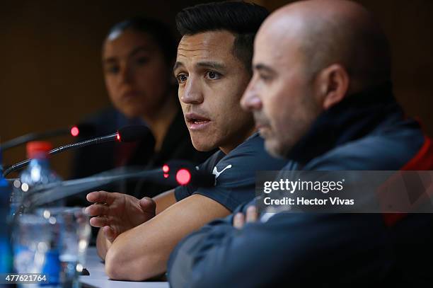 Alexis Sanchez and Jorge Sampaoli, coach of Chile talk during a press conference at Nacional Stadium on June 18, 2015 in Santiago, Chile. Chile will...