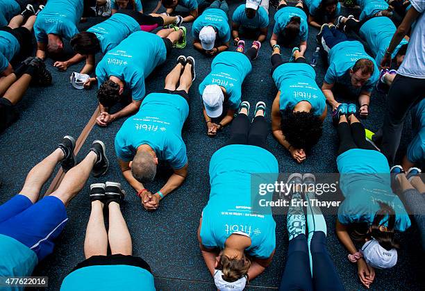 People take part in a Fitbit lunchtime workout event outside the New York Stock Exchange during the IPO debut of the company on June 18, 2015 in New...