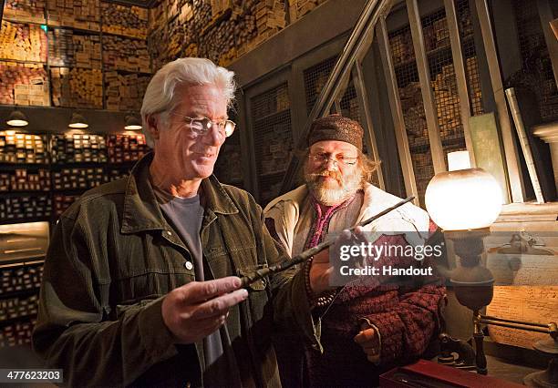 In this handout photo provided by Universal Orlando Resort, Golden Globe award-winning actor Richard Gere visited Ollivanders wand shop at The...