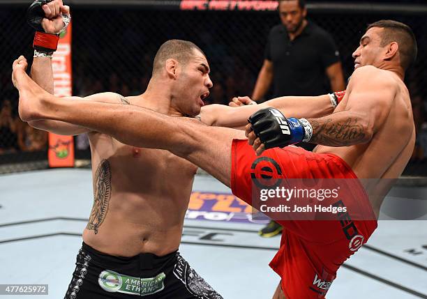 Cain Velasquez punches Fabricio Werdum in their UFC heavyweight championship bout during the UFC 188 event inside the Arena Ciudad de Mexico on June...