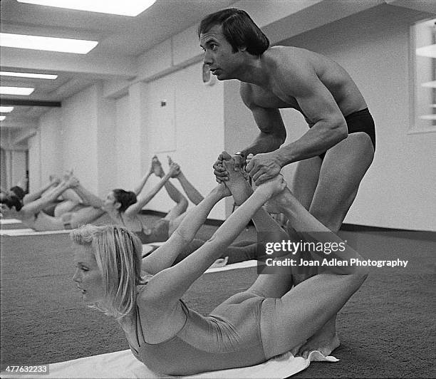 Founder and teacher of Bikram Yoga, Bikram Choudhury assists actress Carol Lynley with the 'Bow Pose' at his yoga studio in Beverly Hills, California.