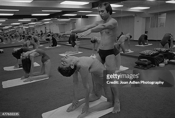 Founder and teacher of Bikram Yoga, Bikram Choudhury assists actor Richard Benjamin with the 'Camel Pose' at his yoga studio in Beverly Hills,...