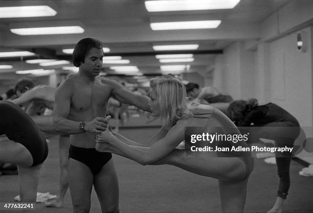 Founder and teacher of Bikram Yoga, Bikram Choudhury assists actress Carol Lynley with the 'Standing Head to Knee Pose' at his yoga studio in Beverly...