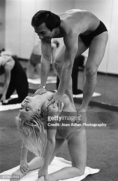 Founder and teacher of Bikram Yoga, Bikram Choudhury assists actress Carol Lynley with the 'Camel Pose' at his yoga studio in Beverly Hills,...
