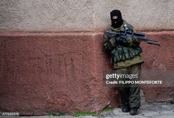 Member of the new pro-Russian forces dubbed the "military forces of the autonomous republic of Crimea" stands guard in the Republican military...