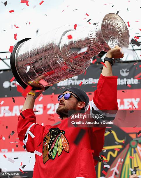 Marcus Kruger of the Chicago Blackhawks holds the Stanley Cup trophy during the Chicago Blackhawks Stanley Cup Championship Rally at Soldier Field on...