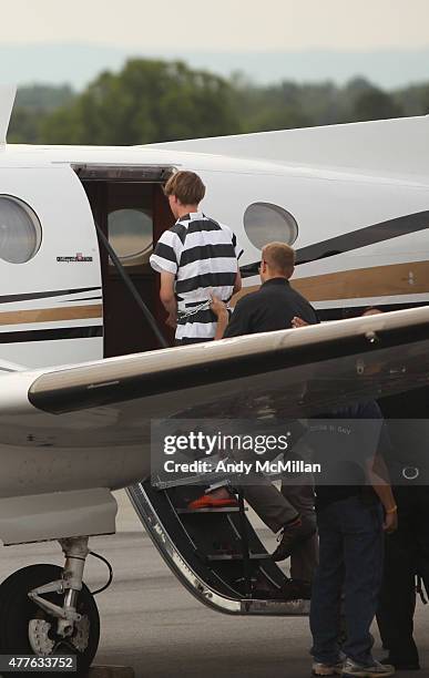 Year-old suspect, Dylann Roof of Lexington, South Carolina, boards a plane at Shelby-Cleveland County Regional Airport for extradition back to...