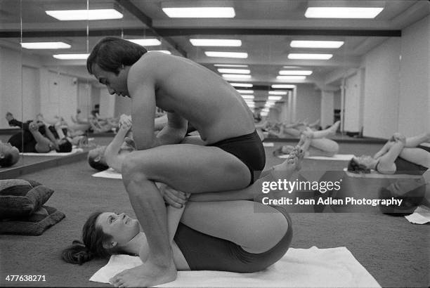 Founder and teacher of Bikram Yoga, Bikram Choudhury assisting a client at his yoga studio in Beverly Hills, California.