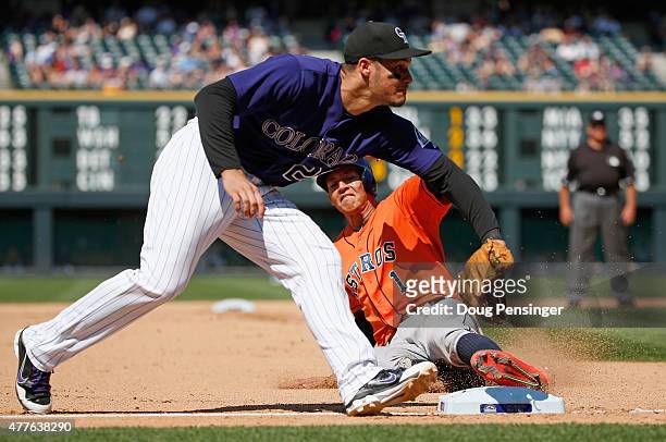 Carlos Correa of the Houston Astros steals third base as third baseman Nolan Arenado of the Colorado Rockies takes the late throw in the seventh...