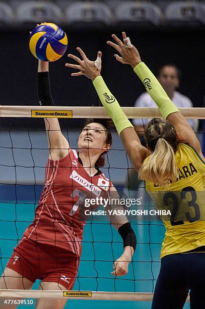 Japan's May Yamaguchi attacks agaisnt Brazil's Barbara Bruch during their volleyball friendly match at Maracanazinho Arena in Rio de Janeiro, Brazil,...