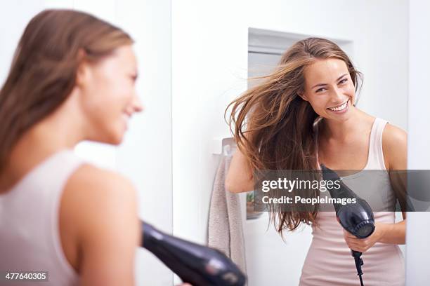 blowdrying her hair - hair dryer stock pictures, royalty-free photos & images