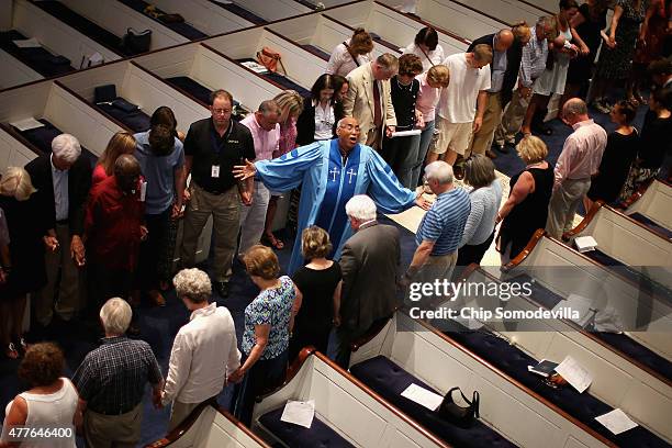 The Rev. Sidney Davis leads mourners during a community prayer service for the nine victims of last night's shooting at the historic Emanuel African...