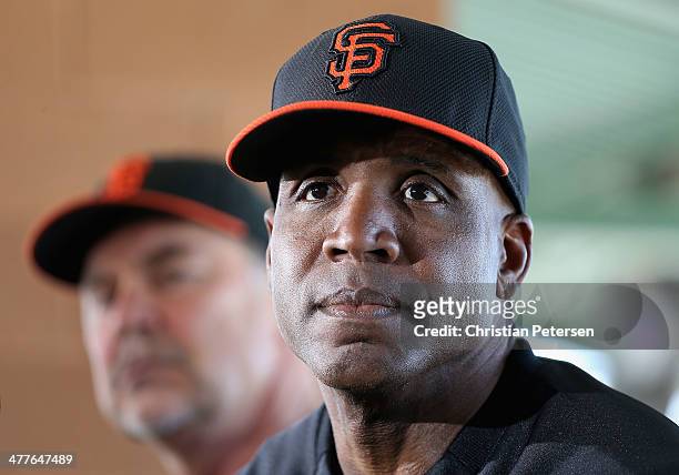 Barry Bonds of the San Francisco Giants speaks alongside manager Bruce Bochy during a press conference about his return to the organization as a...