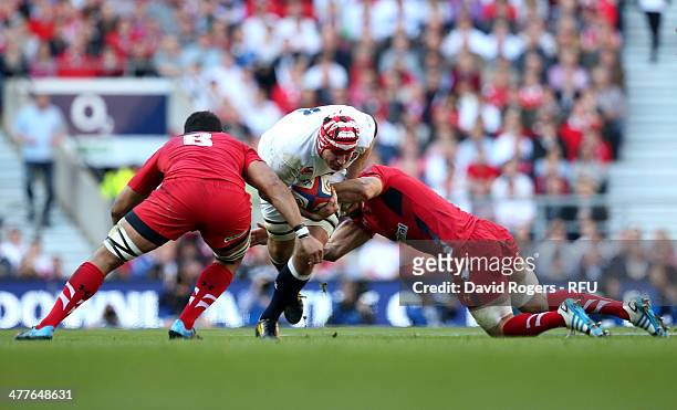 Ben Morgan of England is tackled by Toby Faletau of Wales and Alun Wyn Jones of Wales during the RBS Six Nations match between England and Wales at...