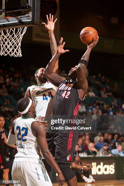 Derrick Caracter of the Idaho Stampede shoots over defenders Mickell Gladness and Mo Charlo of the Reno Bighorns March 7, 2014 at the Reno Events...