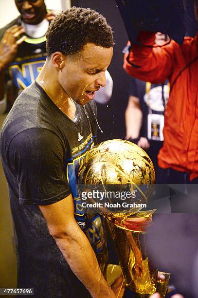 Stephen Curry of the Golden State Warriors celebrates winning the Larry O'Brein Trophy after Game Six of the 2015 NBA Finals against the Cleveland...