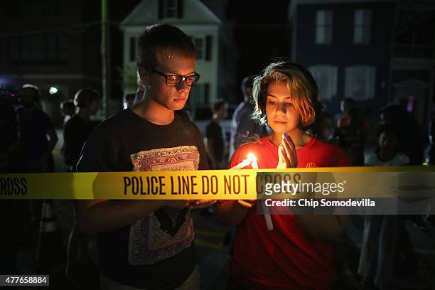 Mourners light candles for the nine victims of last night's shooting at the historic Emanuel African Methodist Episcopal Church June 18, 2015 in...