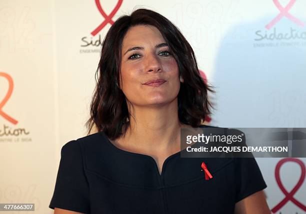 Estelle Denis, host at French tv TF1, poses as she arrives for the Sidaction 2014 launch at the Musee du Quai Branly in Paris. AFP PHOTO / JACQUES...