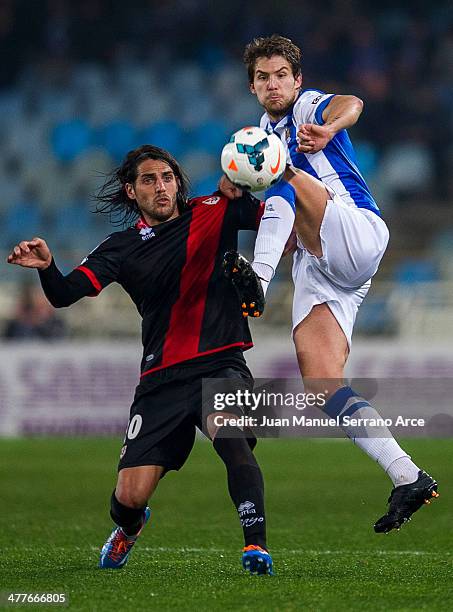 Inigo Martinez of Real Sociedad duels for the ball with Joaquin Larrivey of Rayo Vallecano during the La Liga match between Real Sociedad and Rayo...