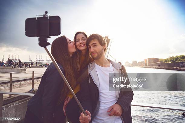 friends taking a selfie stick in hamburg - selfie stick stock pictures, royalty-free photos & images