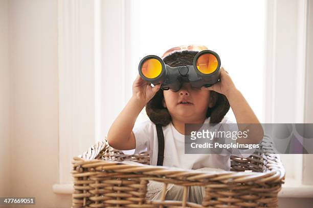 ah! that's where mom hid the candy! - child with binoculas stockfoto's en -beelden