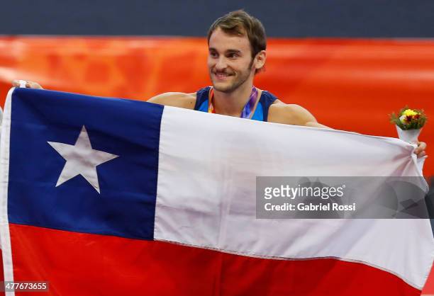 Tomas Gonzalez of Chile holds his national flag in the podium Men's Floor Event during day four of the X South American Games Santiago 2014 at Centro...