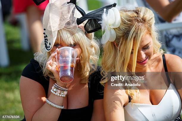 Racegoers watching the races on Ladies Day of Royal Ascot at Ascot racecourse in Berkshire, England on June 18, 2015. The 5 day showcase event, which...