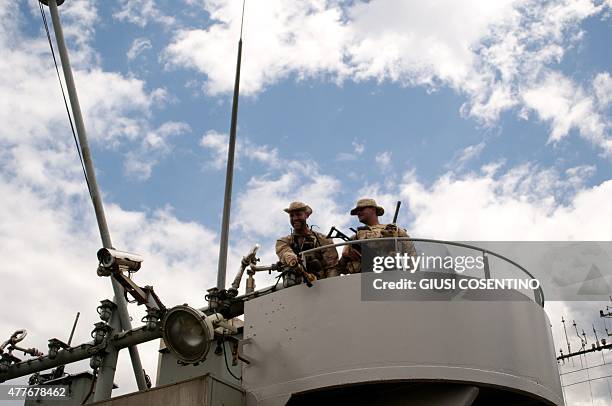 Military personnel stand on deck of the Belgian Navy Vessel Godetia, one of the fleet of EU Navy Vessels taking part in the Triton migrant rescue...