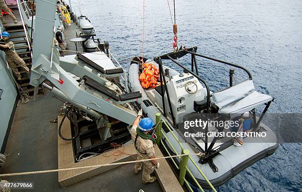 Naval personnel lower a patrol dinghy into the sea from on board the Belgian Navy Vessel Godetia, one of the fleet of EU Navy Vessels taking part in...