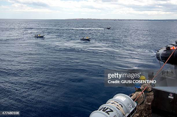 Naval personnel sail past on patrol dinghies after being lowered into the sea from on board the Belgian Navy Vessel Godetia, one of the fleet of EU...