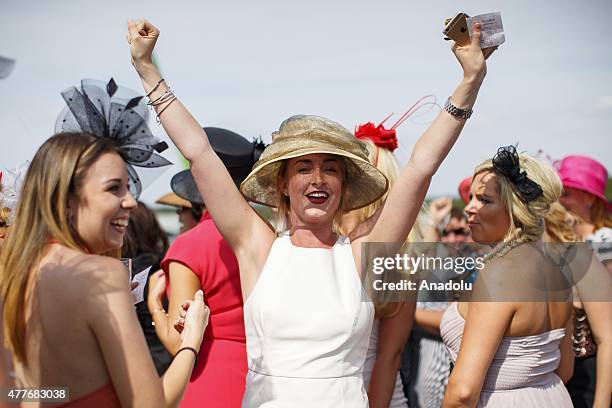 Racegoers celebrating after winning a bet on a race on Ladies Day of Royal Ascot at Ascot racecourse in Berkshire, England on June 18, 2015. The 5...