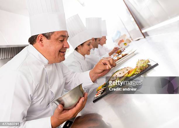 group of chefs cooking - chef competition stock pictures, royalty-free photos & images