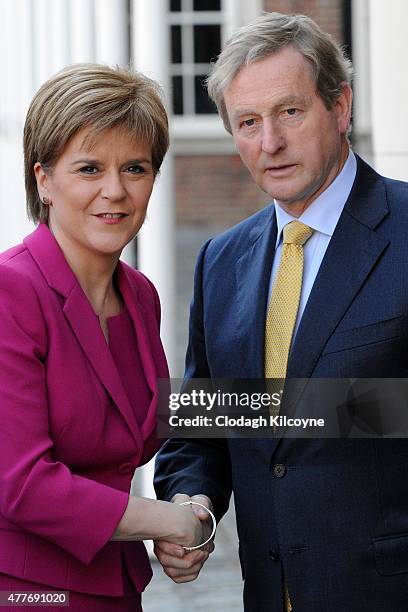 Scottish First Minister Nicola Sturgeon greets Irish Taoiseach Enda Kenny at the 24th British-Irish Council Summit at Dublin Castle on June 19, 2015...