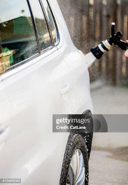 washing a vehicle: hosing down vehicle to remove soap suds - hose stock pictures, royalty-free photos & images