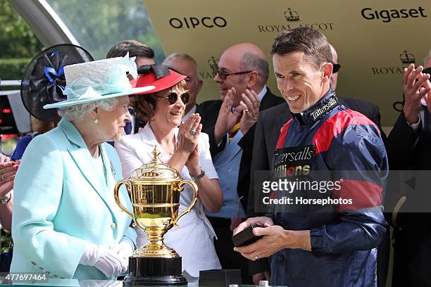 Queen Elizabeth II presents the Gold Cup trophy to Graham Lee on Ladies Day at Royal Ascot Racecourse on June 18, 2015 in Ascot, England.