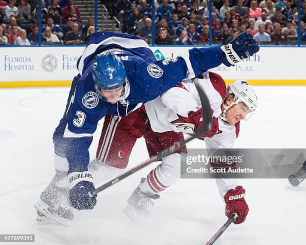 Keith Aulie of the Tampa Bay Lightning is up-ended by Jeff Halpern of the Phoenix Coyotes during the second period at the Tampa Bay Times Forum on...