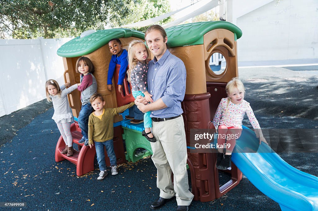 Group of children with adult at preschool playground