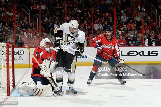 Jaroslav Halak of the Washington Capitals makes a save against Chris Kunitz of the Pittsburgh Penguins in the third period during an NHL game at...