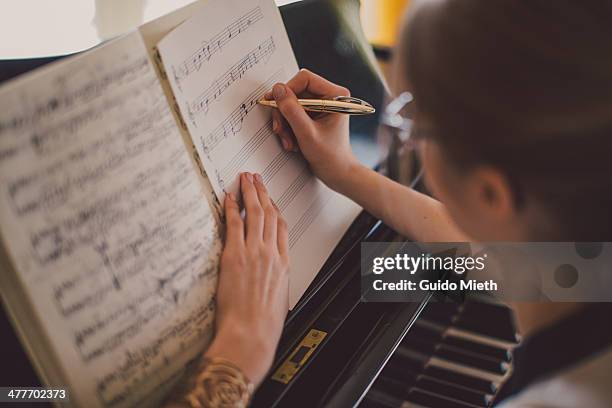 woman writing down music notes - composition stock pictures, royalty-free photos & images