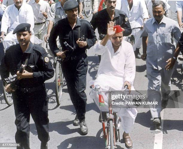 Black Cat commandos escort Samajwadi Party President Mulayam Singh Yadav as he leads a bicycle rally against the state government of Uttar Pradesh...