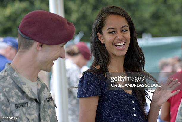 Malia Obama, daughter of US President, smiles as she serves food during a lunch at the United States and Nato military base in Vicenza on June 19,...