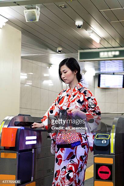 japanese woman wearing a kimono check out in tokyo subway. - japanese exit sign stock pictures, royalty-free photos & images