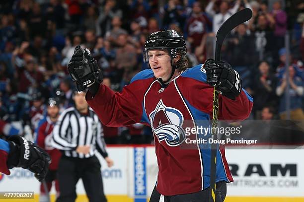 Nathan MacKinnon of the Colorado Avalanche celebrates a second-period goal by teammate John Mitchell (not to take a 1-0 lead over the Winnipeg Jets...
