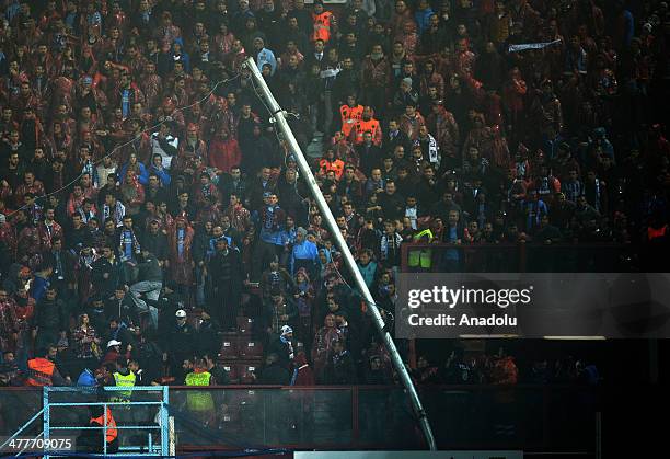 Trabzonspor fans bend the post of 'behind goal netting' during the Turkish Spor Toto Super League's football match between Trabzonspor and Fenerbahce...