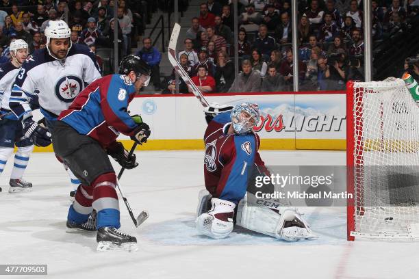 Goaltender Semyon Varlamov and Jan Hejda of the Colorado Avalanche attempt to stop a goal by Dustin Byfuglien of the Winnipeg Jets at the Pepsi...
