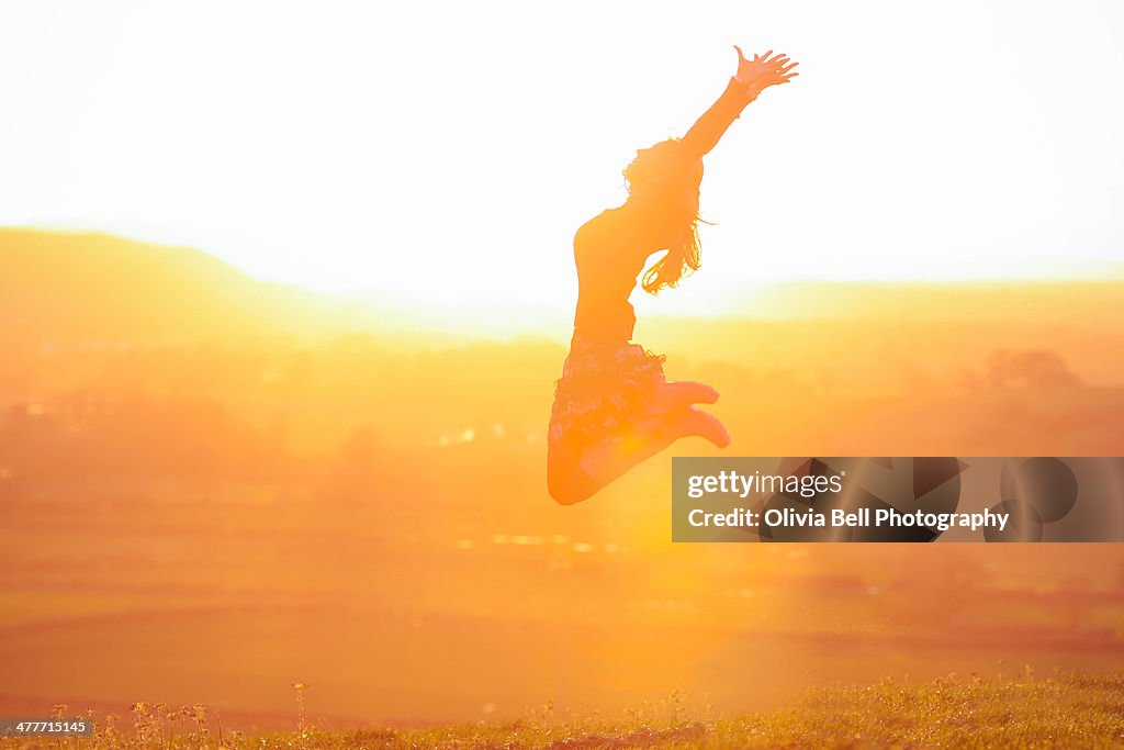 Girl Jumping at Sunset